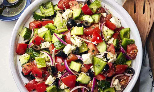 Greek Salad Bowl Classic topped with crumbled feta cheese